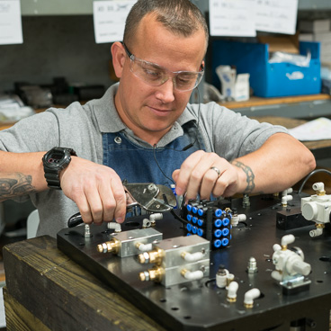 Industrial automation equipment engineer working with pliers 