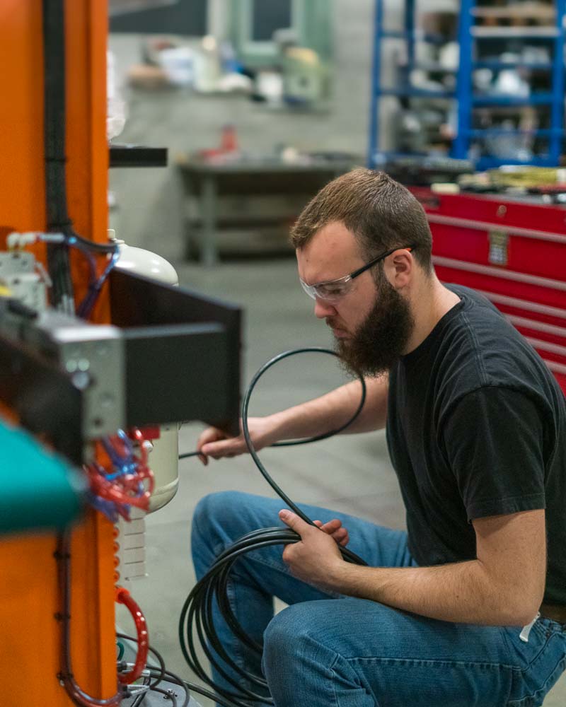 Ahaus employee working on an automation assembly for medical device manufacturing.