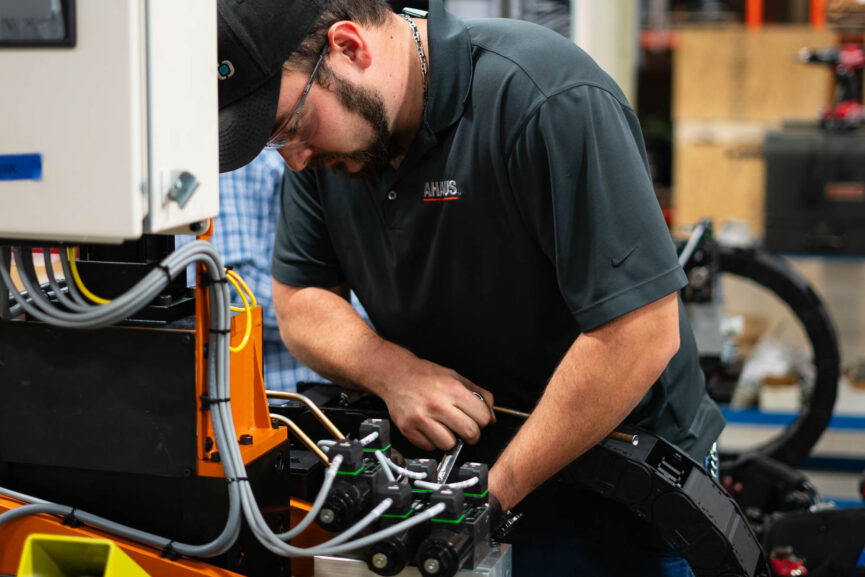 Ahaus employee working on manufacturing automation equipment.